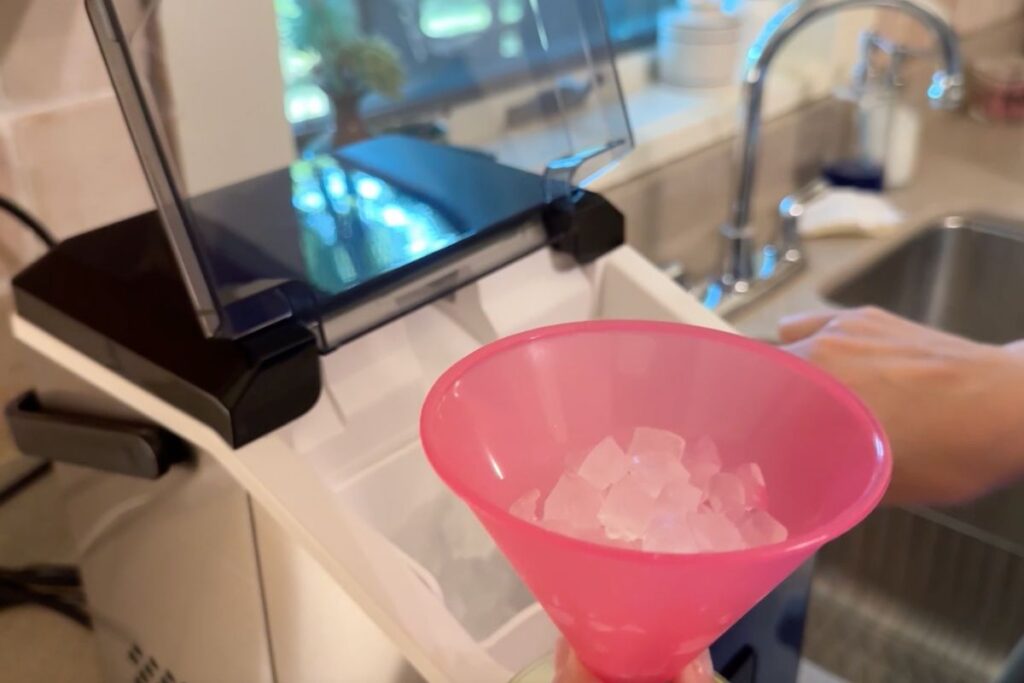 Cup of nugget ice in front of machine