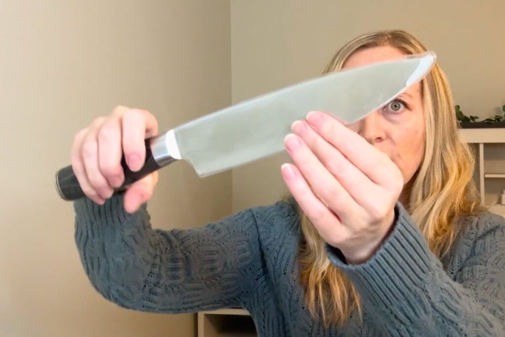 Holding the Cutluxe 8 inch chef knife