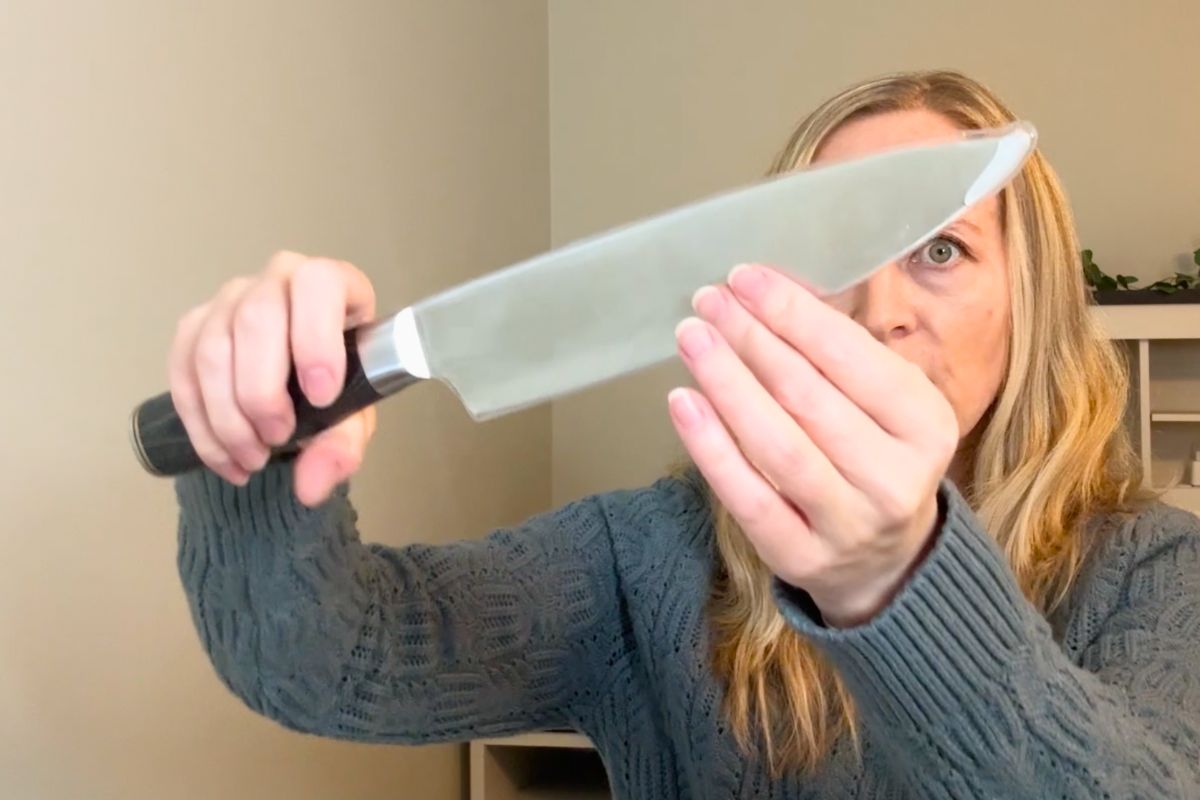 Holding the Cutluxe 8 inch chef knife