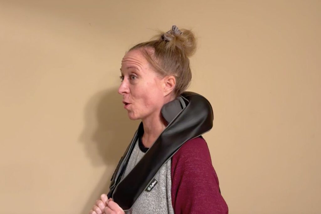 Jen trying the massager with a surprised happy face