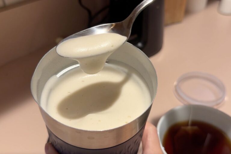 foamy frothed milk in a spoon