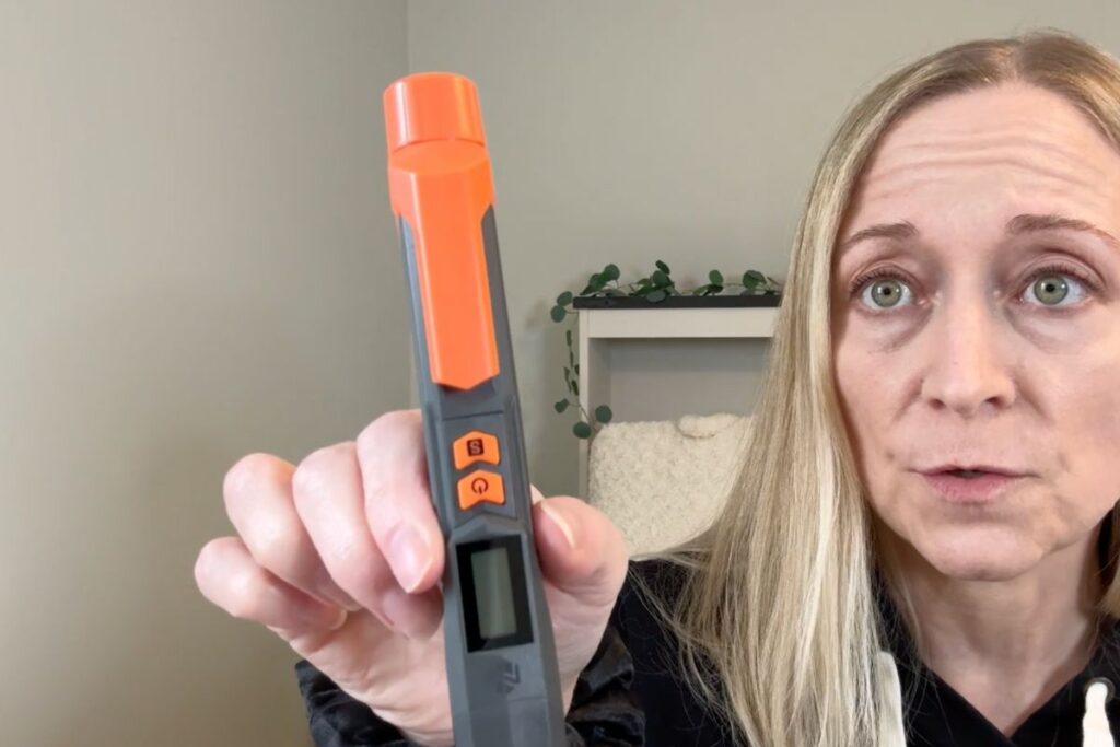 Holding a Neoteck gas leak detector