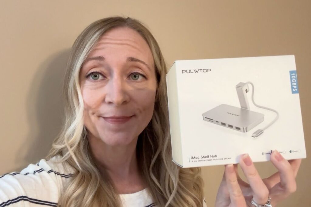 Holding a box with a PULWTOP imac self hub in it.