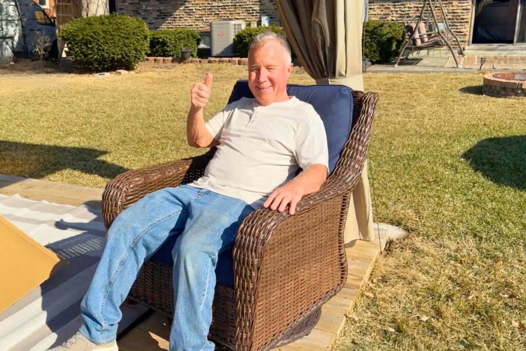 Dad giving a thumbs up in the outdoor patio furniture