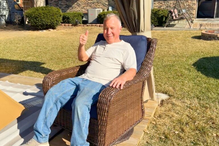 Dad giving a thumbs up in the outdoor patio furniture