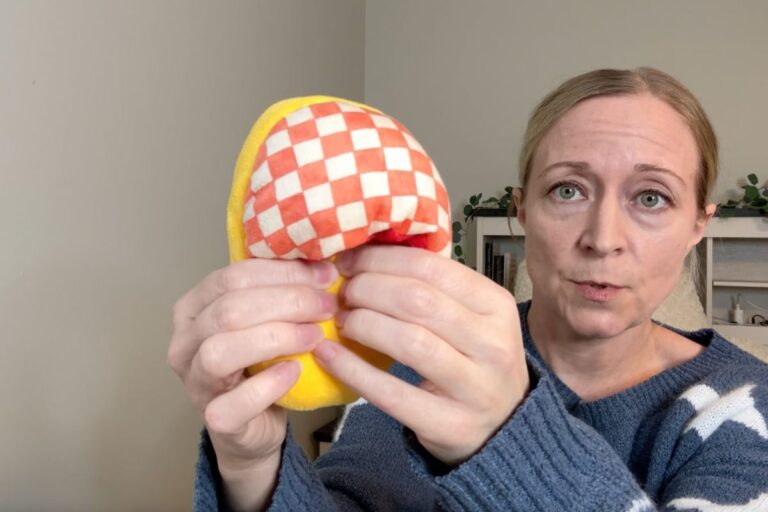 Holding a soft slipper toy for dogs