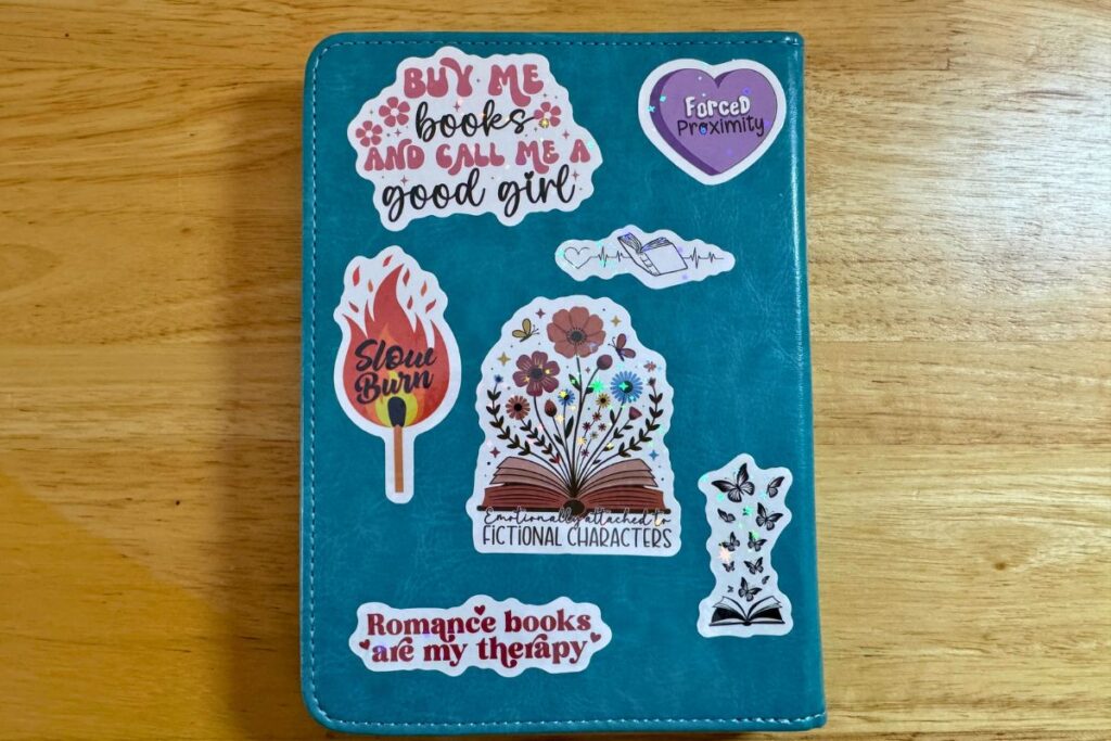Kindle case with spicy romance themed stickers on it