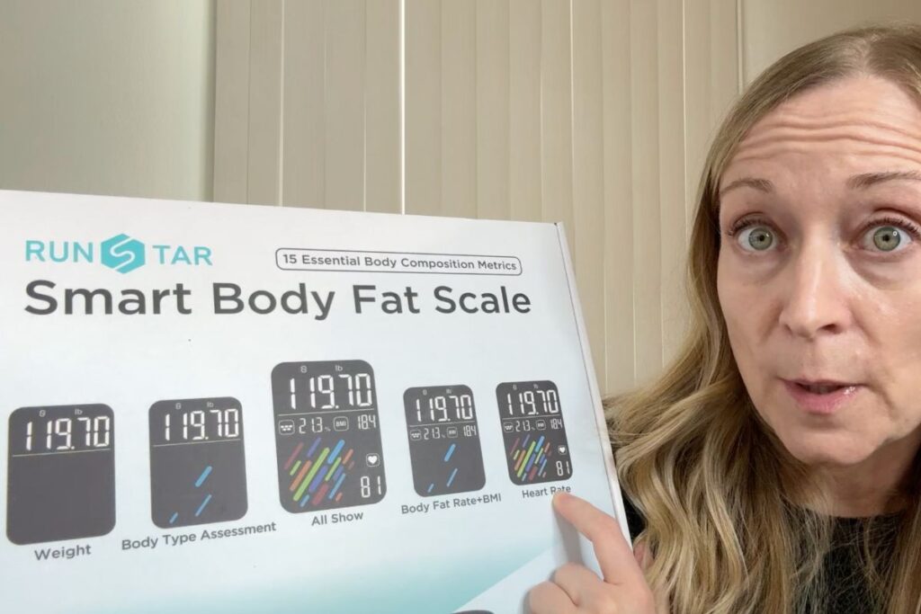 Holding the Runstar smart body scale in the box