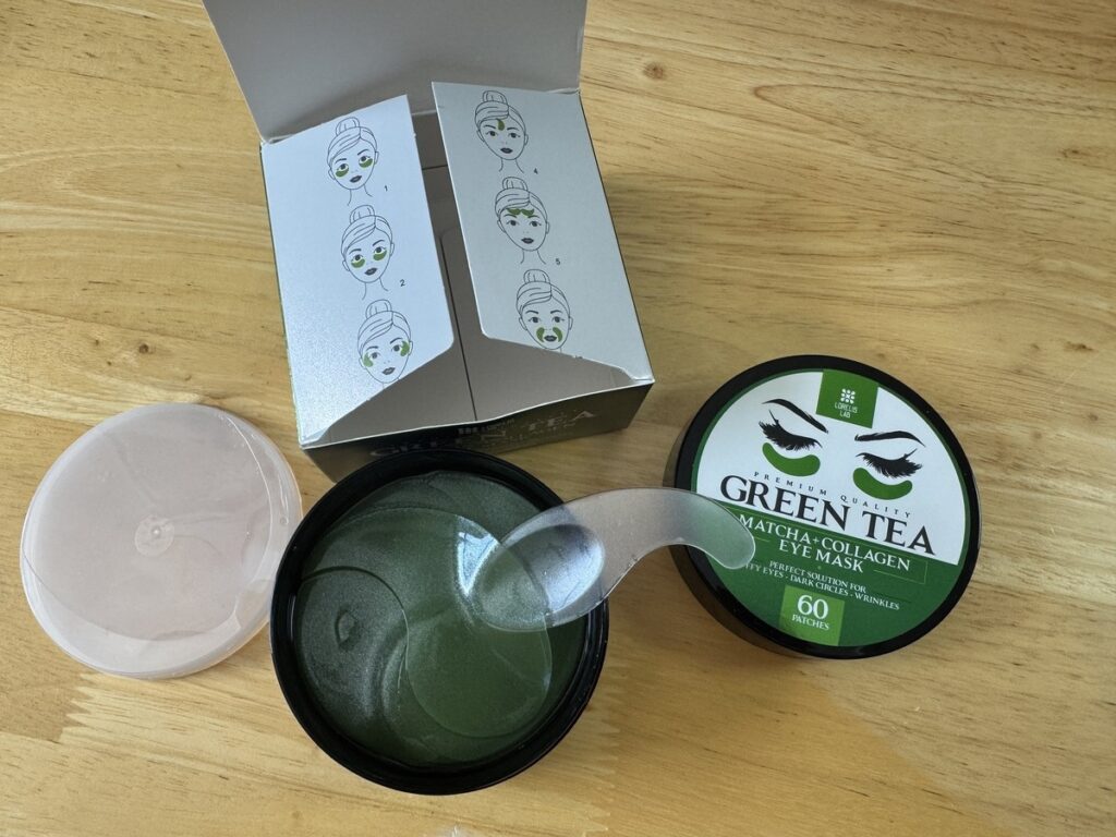 Lorelis Lab Green Tea Matcha and Collagen Eye Mask box and open jar with 60 patches on a wood surface