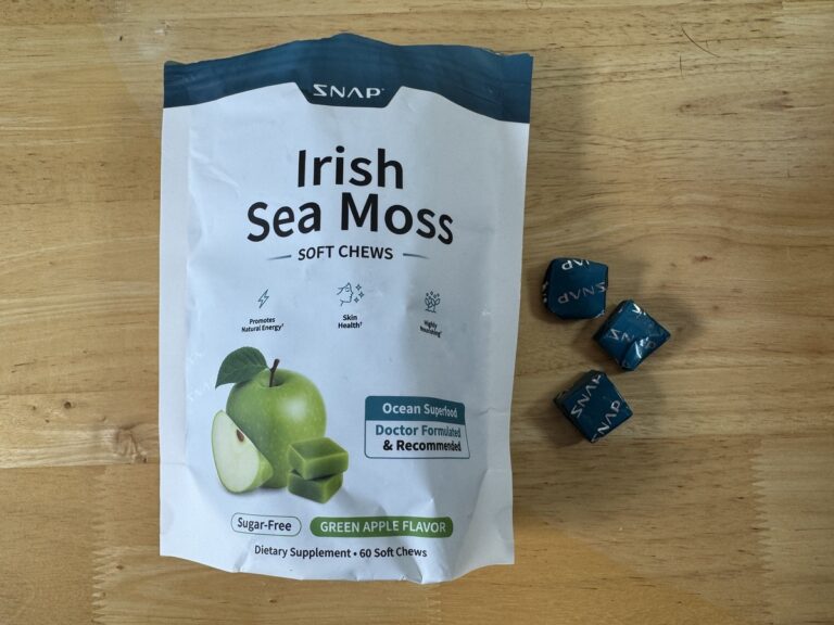 Snap Irish Sea Moss Soft Chews pouch in Green Apple flavor on a wood table with three foil-wrapped chews beside it.