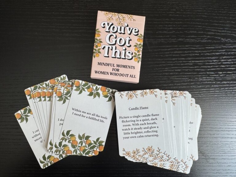 You've Got This Mindful Moments card deck box with floral cards fanned out on a dark wood surface.