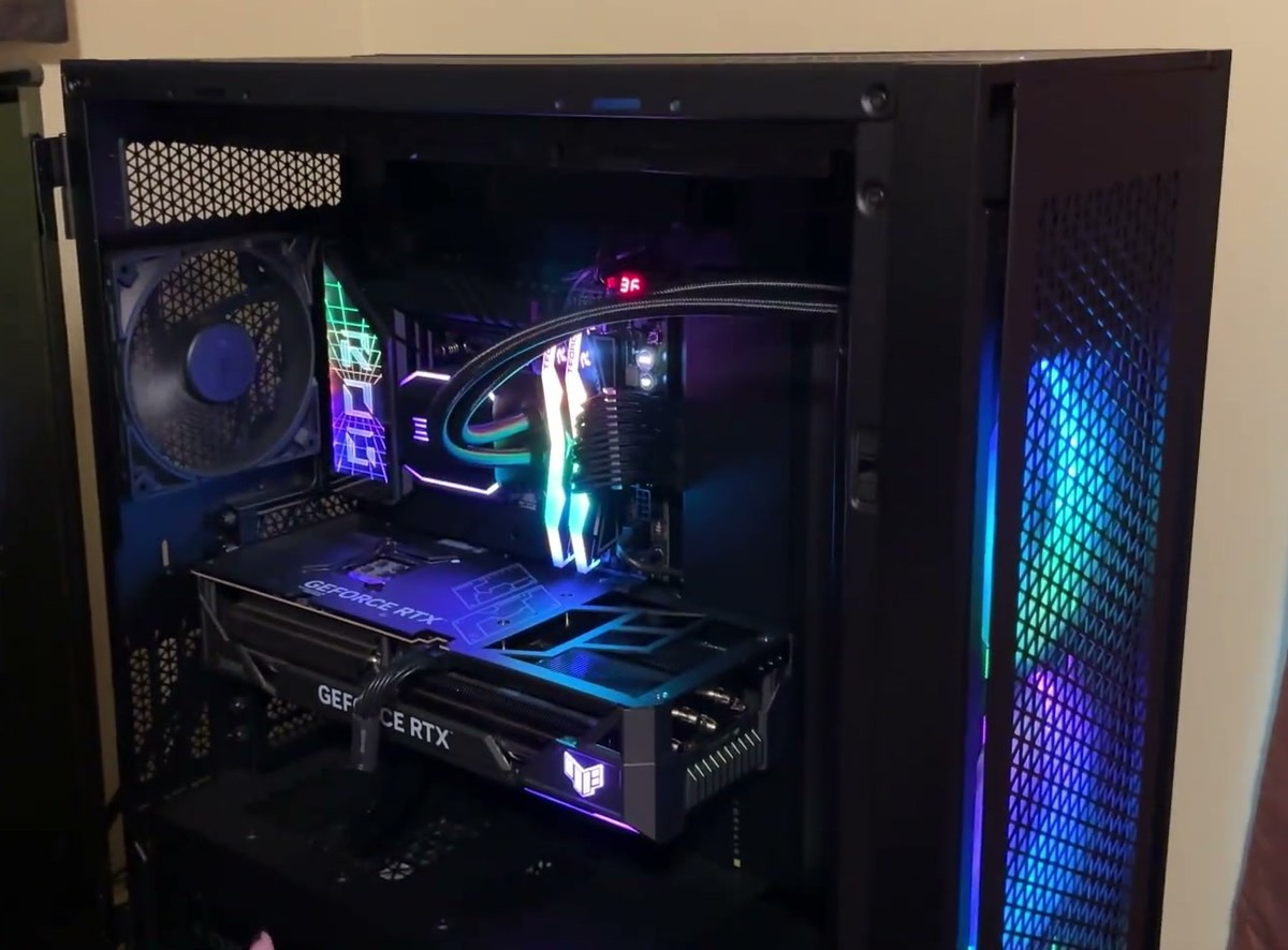 Corsair 7000D AIRFLOW with its tempered glass side panel swung open on its hinge, showing an RTX graphics card, liquid cooler tubing and RGB memory inside