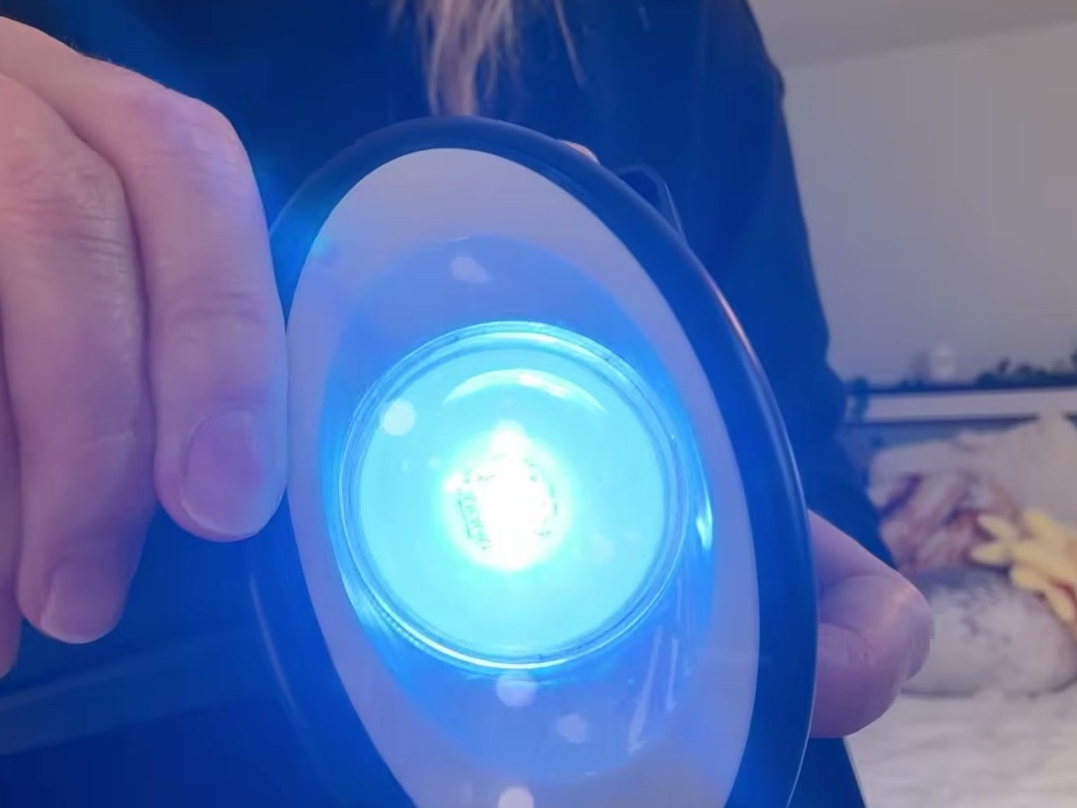 Close-up of a Fuligent solar spotlight lens glowing bright blue in one of its RGB color modes