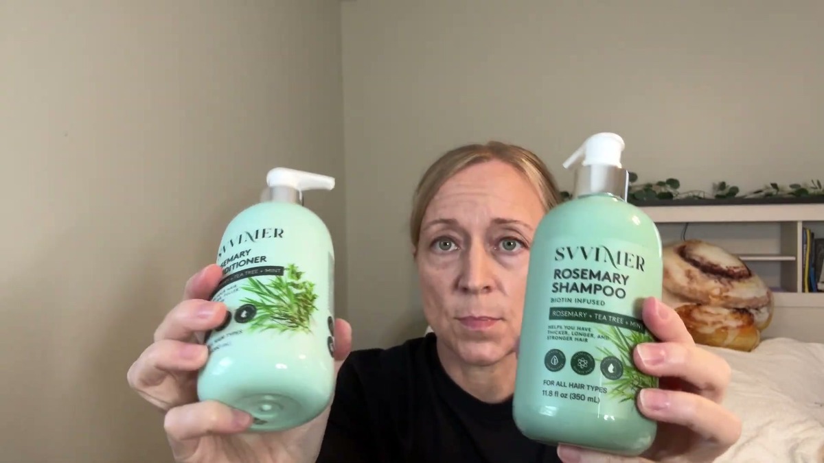 Jen holding up the mint green Svvimer Rosemary Conditioner and Rosemary Shampoo pump bottles, one in each hand