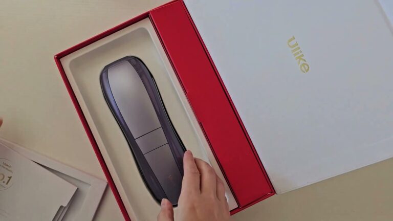 Ulike Air 10 IPL hair removal device sitting in its red and white box, seen from above, a slim purple-gray handset with a flat treatment head
