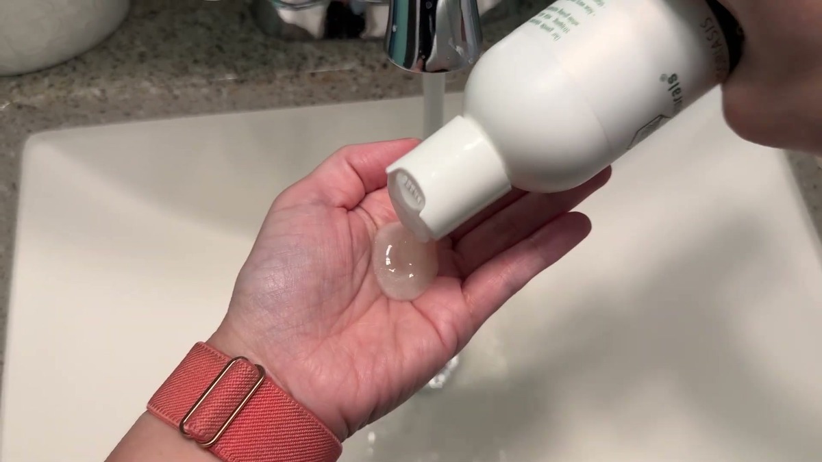 Clear Wild Naturals eczema shampoo squeezed from the bottle into a wet palm over a bathroom sink
