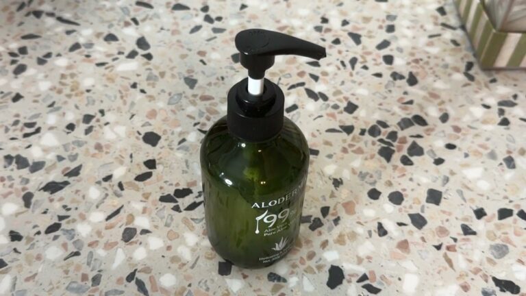 Green Aloderma 99% aloe vera gel pump bottle standing on a speckled terrazzo counter