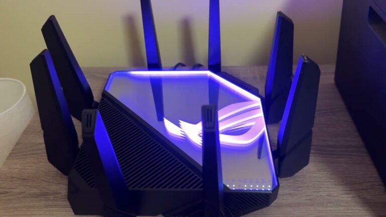ASUS ROG Rapture GT-AXE16000 router with eight black antennas and its top glowing purple with the ROG logo, on a wooden desk