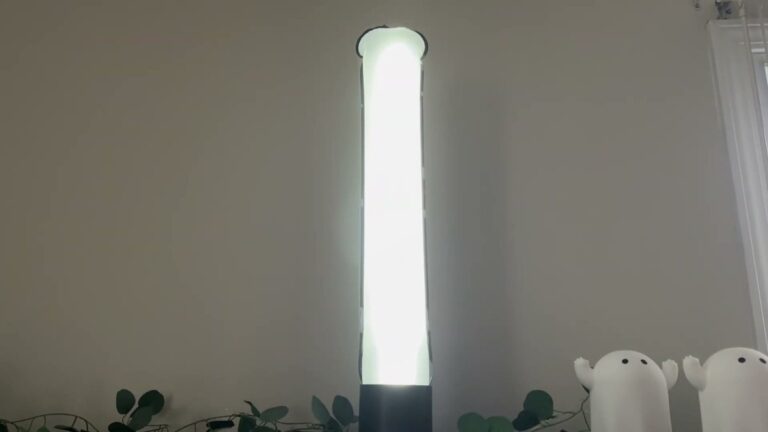 BILTRTE inflatable solar lantern standing upright in its black base on a shelf, the 24-inch tube glowing bright white