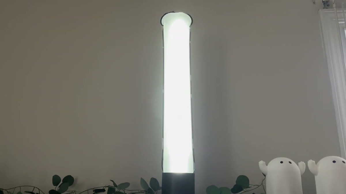 BILTRTE inflatable solar lantern standing upright in its black base on a shelf, the 24-inch tube glowing bright white