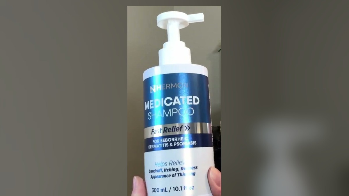 White Hermon Medicated Shampoo pump bottle with a blue label listing dandruff, itching, redness and appearance of thinning, 300 mL