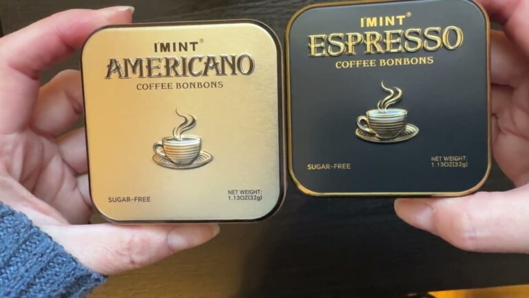 Two I'MINT coffee bonbon tins held side by side, a gold Americano tin and a black Espresso tin, both labeled sugar-free