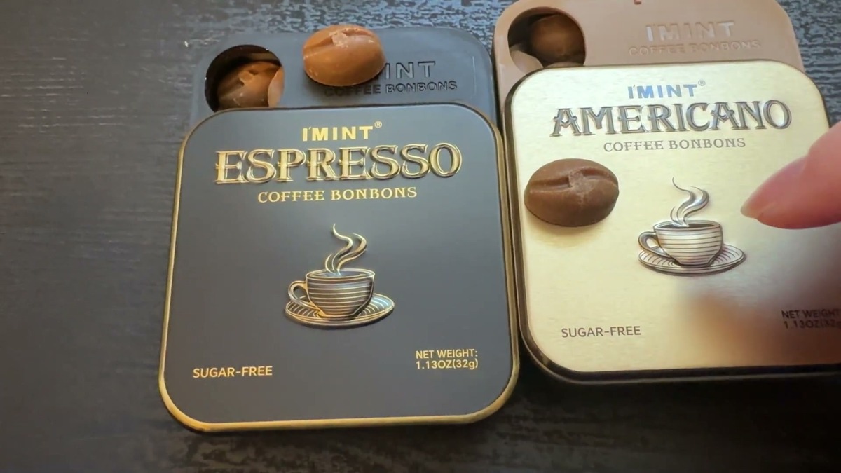 I'MINT Espresso and Americano tins slid open on a table with bean-shaped coffee candies sitting on top