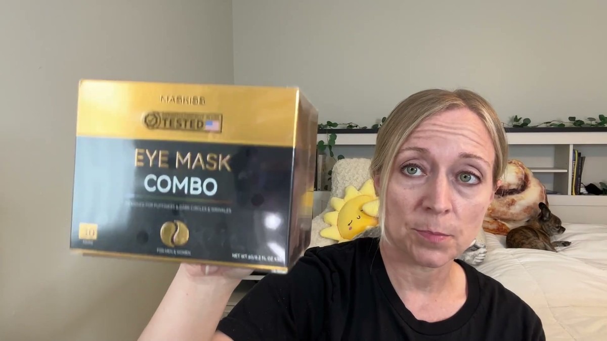 Jen holding up the gold and black Maskiss Eye Mask Combo box of 30 under eye patch pairs in a bedroom