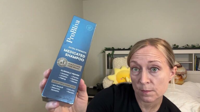 Jen holding up the blue ProBliva Extra Strength Medicated Shampoo box, which lists itchiness, irritation, flaking, dryness, redness and oiliness