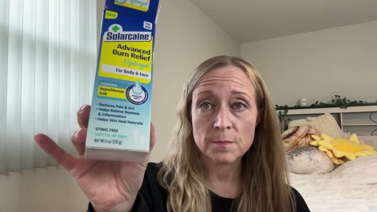 Jen holding up the blue and yellow Solarcaine Advanced Burn Relief Hydrogel box, labeled for body and face and sting free