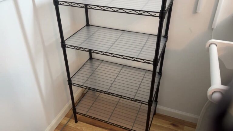 Black SONGMICS 7-tier wire shelving unit with clear plastic liners on each shelf, standing in the corner of a small office