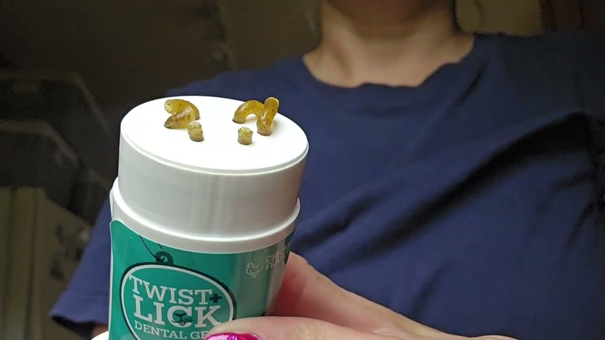 Twist + Lick Dental Gel stick held upright with small amber squiggles of gel twisted up onto the white top